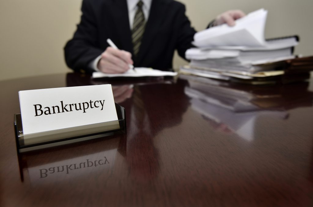Bankruptcy attorney or accountant sitting at desk with files and