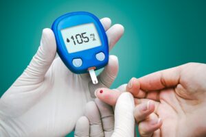Doctor making blood sugar test. Hands with gloves on medical background Doctor making blood sugar test. Hands with gloves on medical background