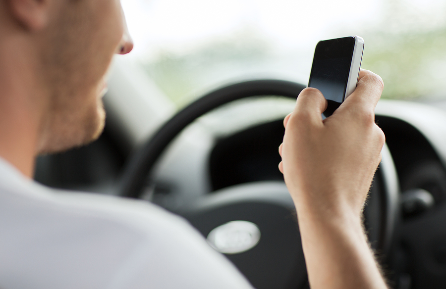 transportation and vehicle concept - man using phone while drivi transportation and vehicle concept - man using phone while drivi