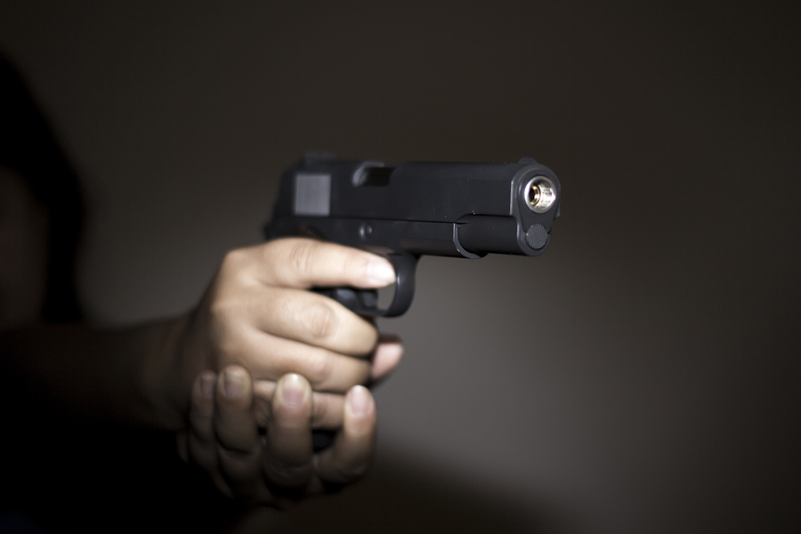Hand holding gun Hand holding gun