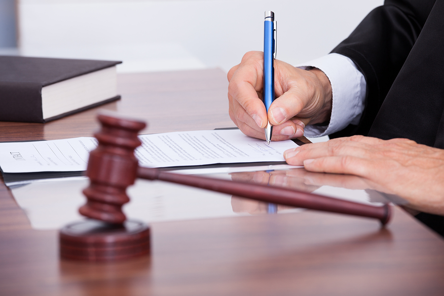 Male Judge Writing On Paper Male Judge Writing On Paper