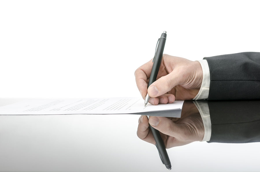 Signing A Contract On A Black Table Signing A Contract On A Black Table