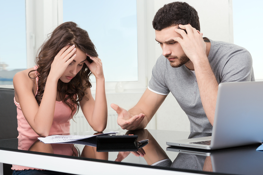man upset after looking at card statement.